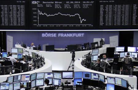 Traders are pictured at their desks in front of the DAX board at the Frankfurt stock exchange June 2, 2014. REUTERS/Remote/Stringer