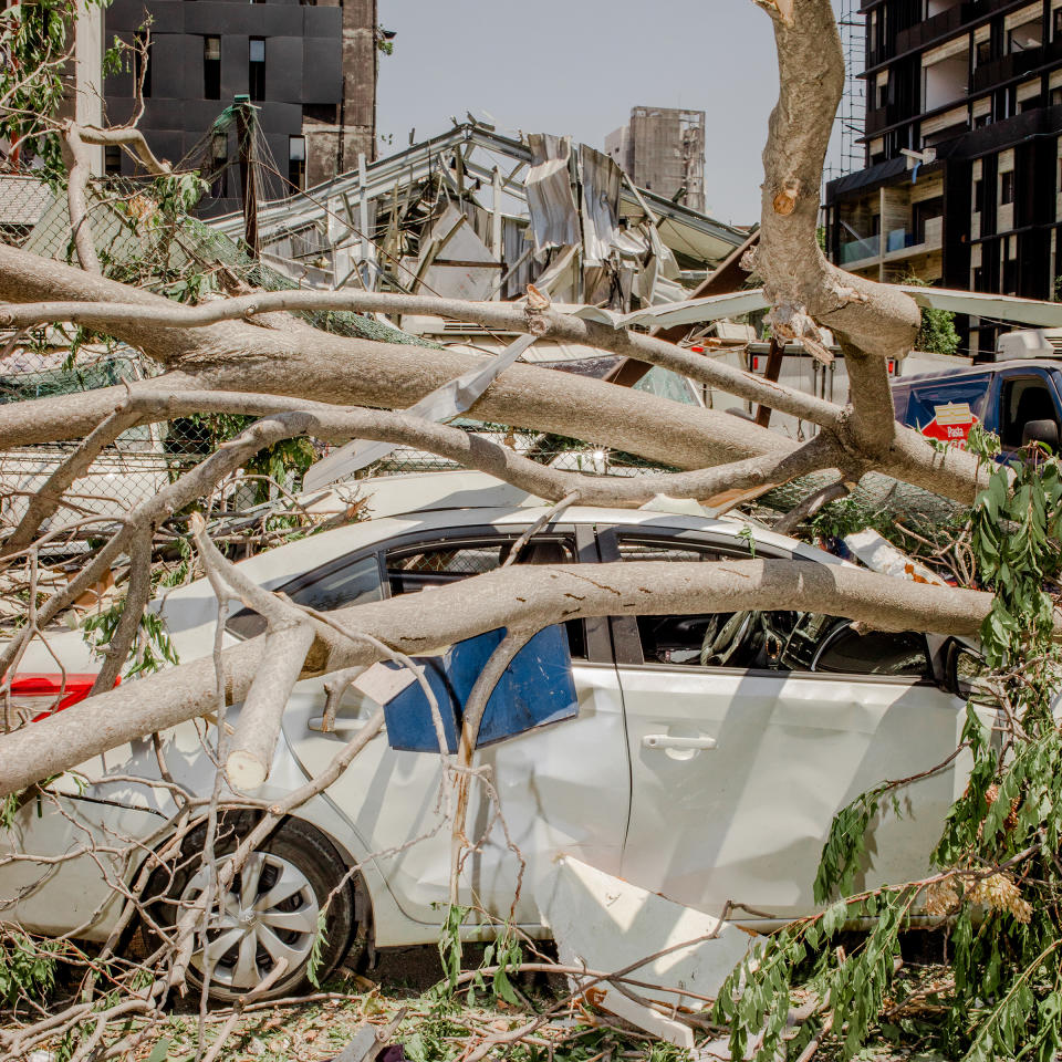 Branches rest on a sedan. The blast, estimated at one tenth the size of the atomic explosion at Hiroshima, sent a wave of destruction six miles across a city already reeling from shortages of food, water and electricity. | Myriam Boulos for TIME