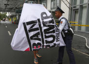 <p>A private guard of Trump Tower prevents a protester from unfurling a banner during a rally to protest the visit of U.S. President Donald Trump, Thursday, Nov. 9, 2017, in the financial district of Makati city, east of Manila, Philippines. (Photo: Bullit Marquez/AP) </p>