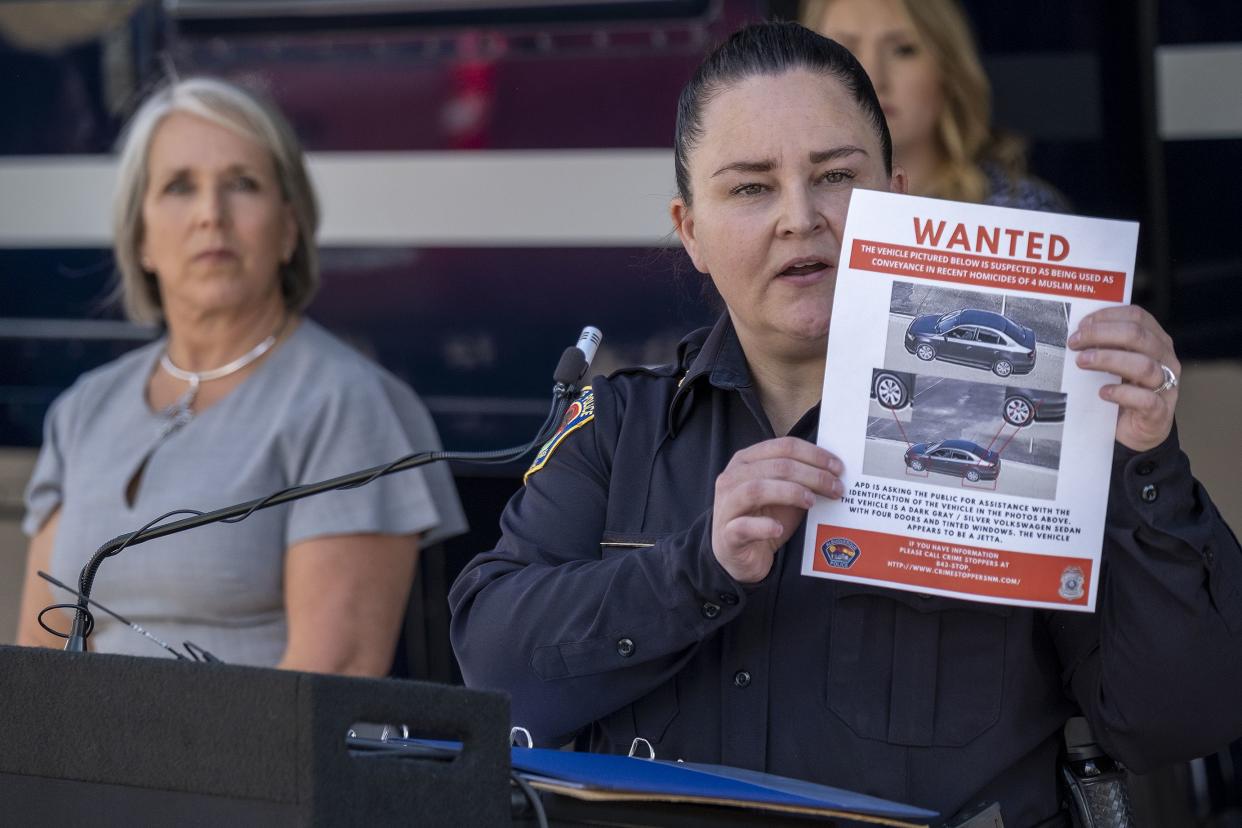 Albuquerque Police Deputy Chief of Investigations Cecily Barker holds a flyer with photos of a car wanted in connection with the murders of Muslim men. 