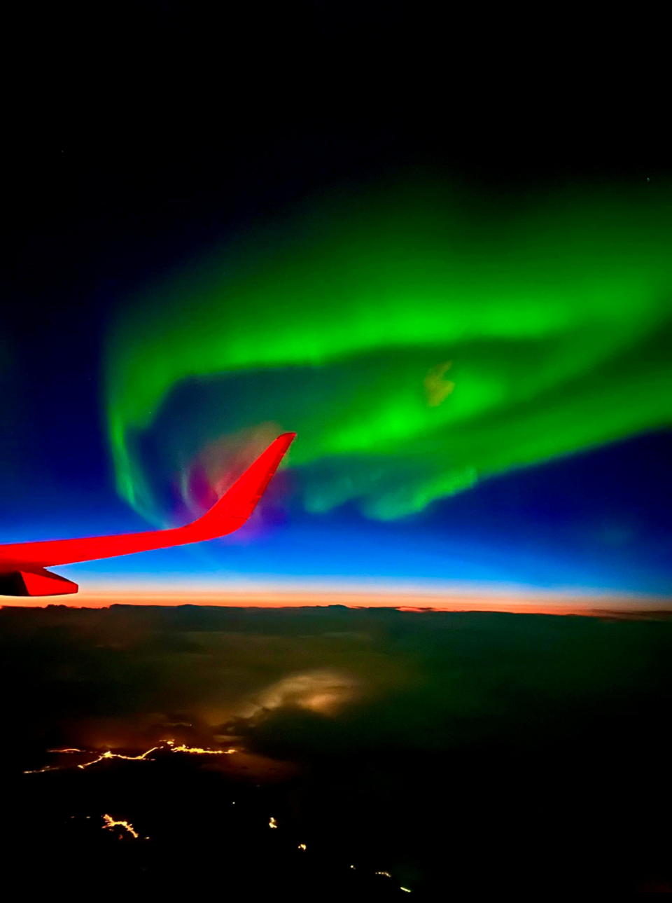 SEE SWNS STORY SWNAauroraplane --- A delayed flight meant a jaw-dropping display of the northern lights for an Essex photographer. Paul Botten, 50, found his journey home from Norway delayed on Thursday (23 Feb), but the resulting night flight meant a stunning show of aurora. He managed to snap the vibrant colours on his iPhone at 30,000ft.