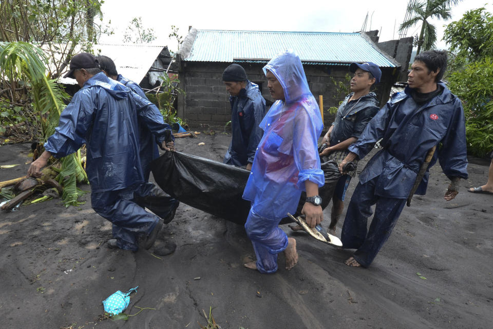 Rescuers carry the body of a man that drowned in floods as Typhoon Goni hit Guinobatan, Albay province, central Philippines, Sunday, Nov. 1, 2020. The super typhoon slammed into the eastern Philippines with ferocious winds early Sunday and about a million people have been evacuated in its projected path, including in the capital where the main international airport was ordered closed. (AP Photo)