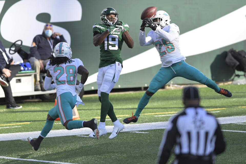 Miami Dolphins' Xavien Howard, right, breaks up a pass intended for New York Jets' Breshad Perriman, center, during the first half of an NFL football game, Sunday, Nov. 29, 2020, in East Rutherford, N.J. (AP Photo/Bill Kostroun)