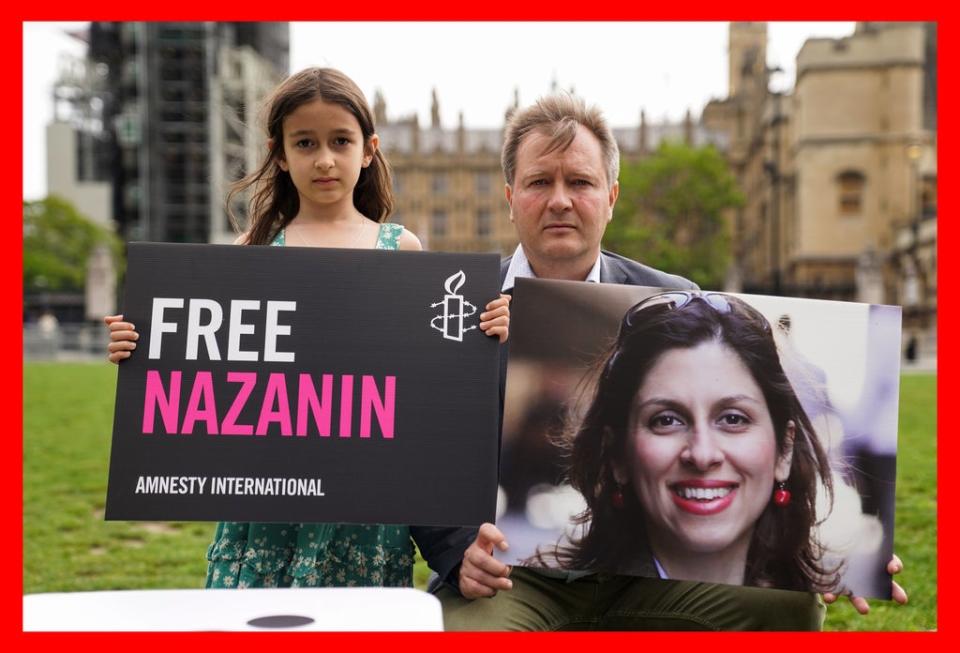 Richard Ratcliffe and his daughter, Gabriella, protest in Parliament Square, London about the continued detention of Nazanin Zaghari-Ratcliffe (Kirsty O’Connor/PA) (PA Media)