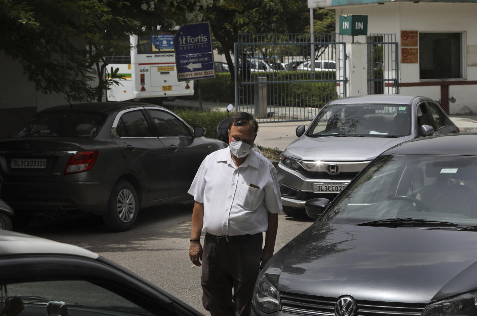 Anil Sharma leaves a hospital after visiting his son Saurav who is being treated for COVID-19 at a private hospital in New Delhi, India, Thursday, July 1, 2021. Life is tentatively returning to normal in India as coronavirus cases fall. But millions are embroiled in a nightmare of huge piles of medical bills. Most Indians don't have health insurance and costs for COVID-19 treatment have them drowning in debt. (AP Photo/Manish Swarup)