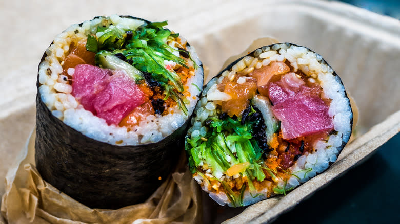 sushi rolls in takeout container