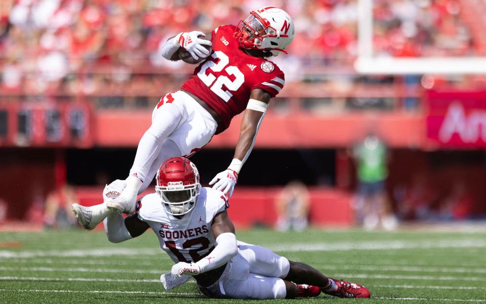 Nebraska's Gabe Ervin Jr. (22) gets tripped up by Oklahoma's Key Lawrence (12) during the second half of an NCAA college football game Saturday, Sept. 17, 2022, in Lincoln, Neb. Oklahoma won 49-14. (AP Photo/Rebecca S. Gratz)