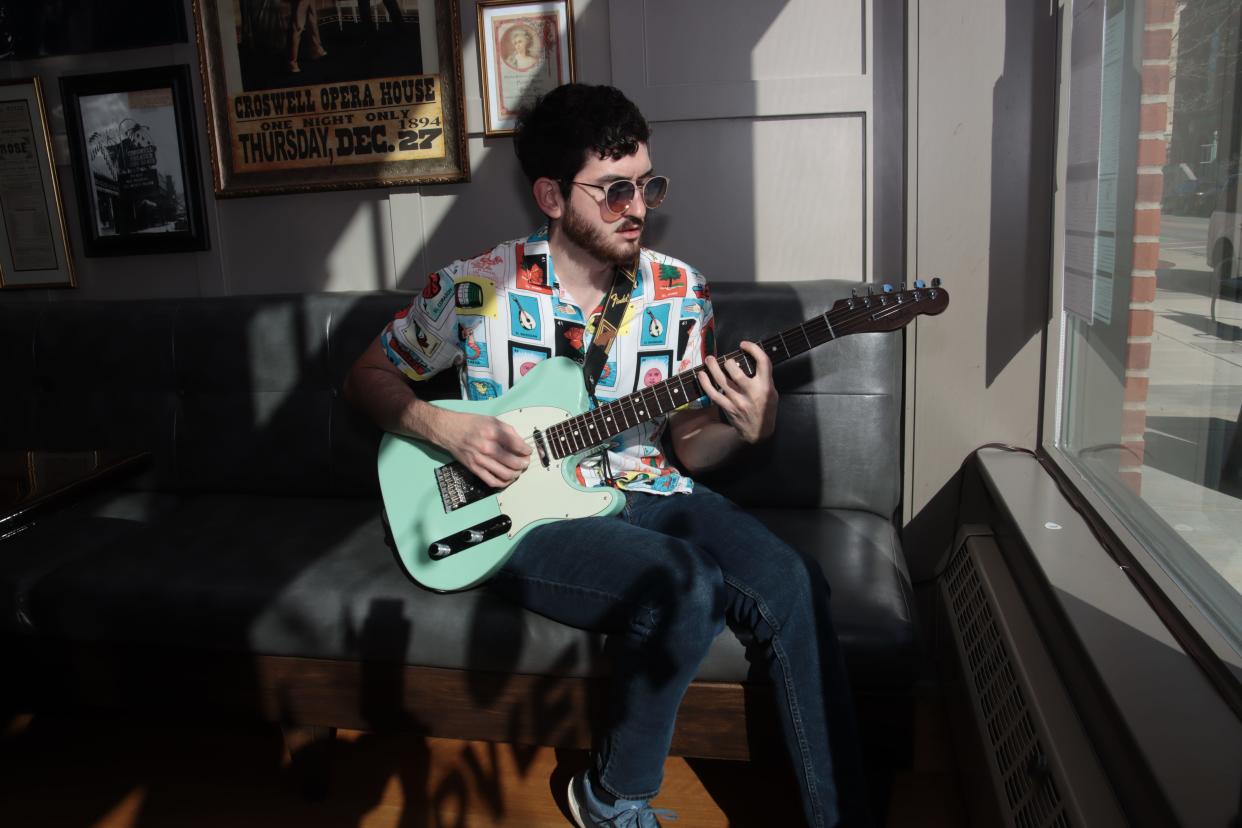 Musician Jonathan Crayne, poses for a photo May 7 at Farver's at the Croswell in Adrian. He recently released his first CD, "Oknow." He sings and plays guitar and other instruments on the album.