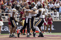 Missouri quarterback Connor Bazelak, facing, congratulates teammate Barrett Banister (11) after Bannister scored a touchdown in the first half of an NCAA college football game against Boston College, Saturday, Sept. 25, 2021, in Boston. (AP Photo/Mary Schwalm)