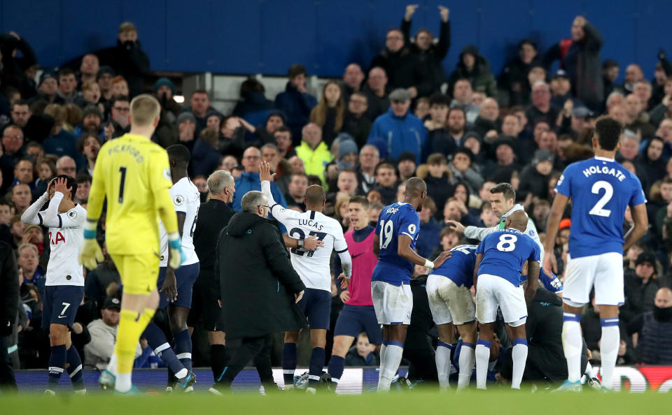 Everton check on the condition of team-mate Andre Gomes as referee Martin Atkinson consoles Tottenham Hotspur's Son Heung-min (left) after a challenge during the Premier League match at Goodison Park, Liverpool. (Photo by Nick Potts/PA Images via Getty Images)