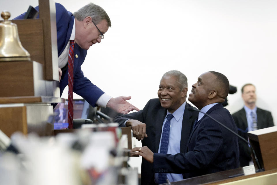 FILE - House Speaker Tim Moore, R-Cleveland, left, talks with state Sen. Dan Blue, D-Wake, center, and House Minority Leader Robert Reives, D-Chatham, right, before the House went into session where redistricting bills were taken under consideration at the Legislative Building, Tuesday, Oct. 24, 2023, in Raleigh, N.C. A federal lawsuit filed Monday, Nov. 20, 2023, in North Carolina alleges newly adopted district boundaries for the state Senate divide a cluster of predominantly Black counties in the northeast corner of the state in a way that will unfairly dilute the voting power of Black residents. (AP Photo/Chris Seward, File)