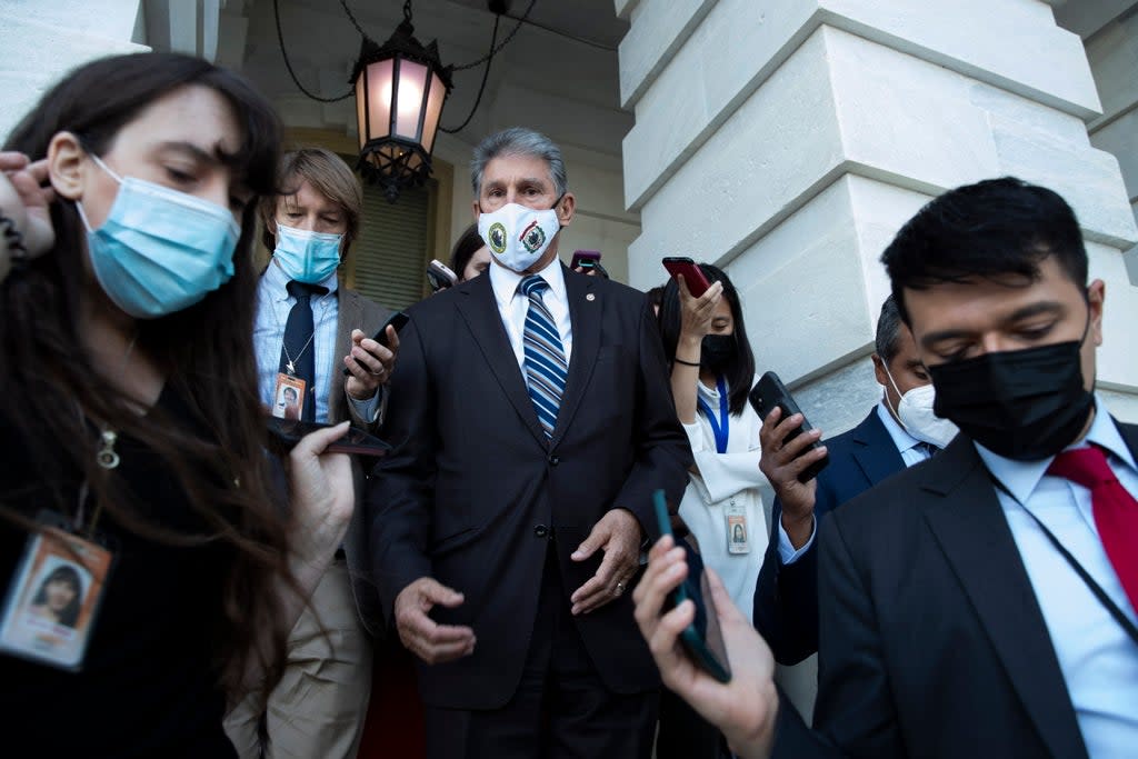 Democratic Senator from West Virginia Joe Manchin (C) is followed by members of the news media after leaving the Senate chamber during a procedural vote on raising the debt limit, on Capitol Hill in Washington, DC (EPA)