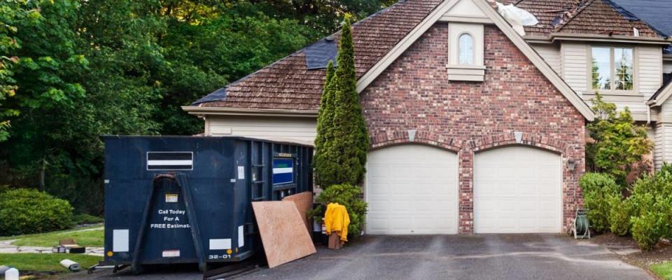 Re-roofing suburban house: old cedar shakes partially removed