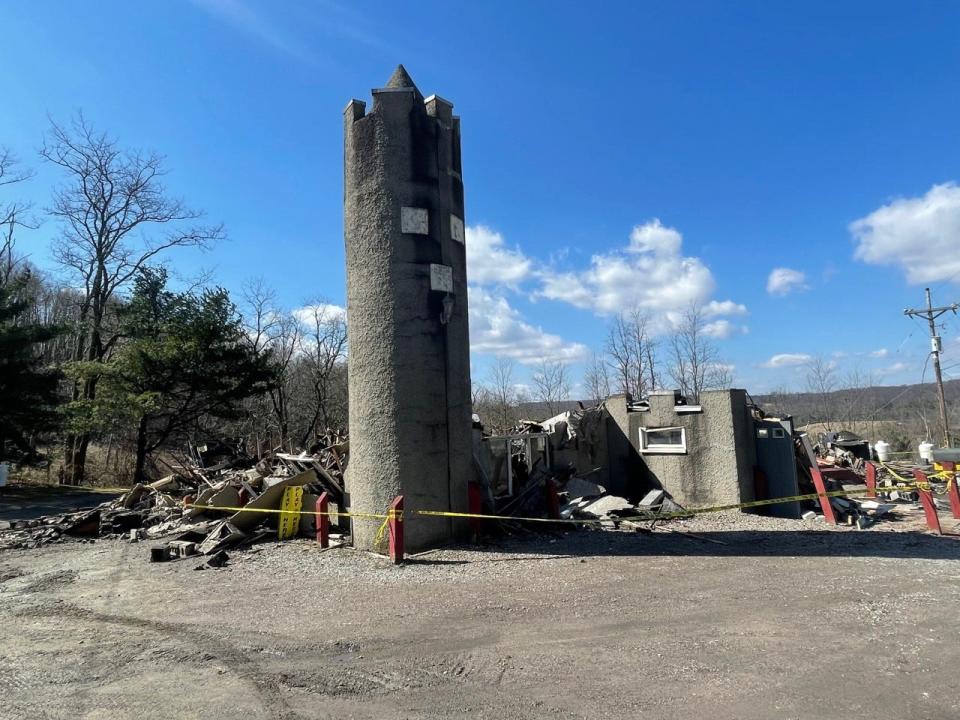 The walls of the Kings & Queens Restaurant and Pub, 4533 Lincoln Highway, were rocking, so a excavator was called in to take down what was left of the building after the fire Saturday.