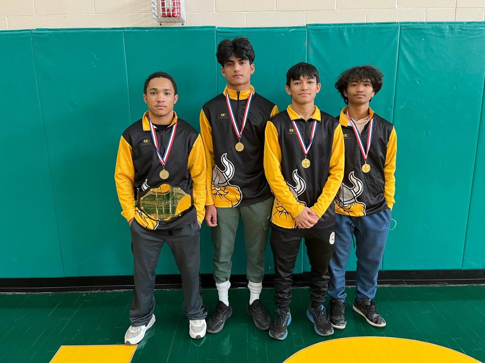 Elijah Gervins of North, left, stands with teammates Dipesh Chuwan, Sanjil Magar and Avinash Mongar after the City Series Wrestling Tournament at Firestone High School in Akron on Feb. 4, 2023.