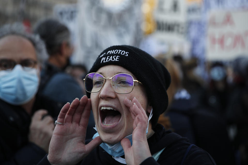 A protester shouts during a demonstration security law that would restrict sharing images of police, Saturday, Nov. 28, 2020 in Paris. Critics of a proposed French security law in France that would restrict sharing images of police are gathering across the country in protest. Civil liberties groups and journalists are concerned that the measure will stymie press freedoms and allow police brutality to go undiscovered and unpunished. (AP Photo/Francois Mori)