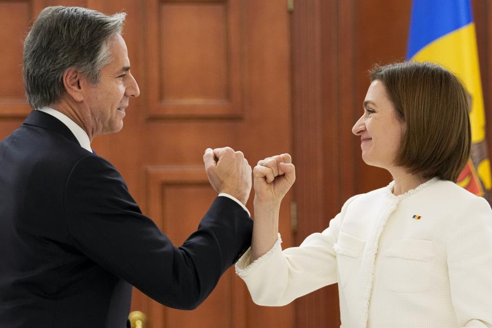 U.S. Secretary of State Antony Blinken, left, and Moldova's President Maia Sandu greet each other as they arrive to attend a joint news conference following their talks in Chisinau, Moldova, Sunday, March 6, 2022. Blinken is in Moldova pledging America’s support to the small Western-leaning former Soviet republic that is coping with an influx of refugees from Ukraine and warily watching Russia’s intensifying war with its neighbor. (AP Photo/Sergei Grits)