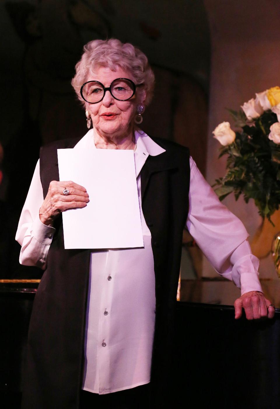 This April 2, 2013 image released by the O+M Company shows Elaine Stritch performing her final engagement at the Cafe Carlyle in New York. Stritch kicked off a final series of concerts to bid farewell to New York on Tuesday, refusing to be maudlin and instead weaving her typical brand of sass and feistiness. Stritch plans to retire to Birmingham, Mich. a suburb of Detroit, after seven decades in New York City. She ends her five-show farewell on Saturday.(AP Photo/The O+M Company, Walter McBride)