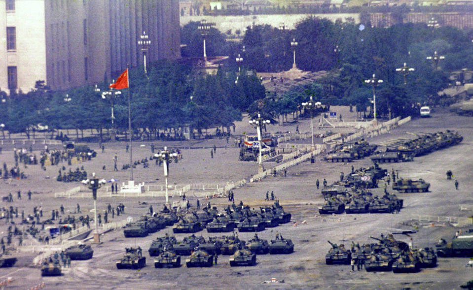 FILE - Chinese troops and tanks gather in Beijing, one day after the military crackdown that ended a seven week pro-democracy demonstration on Tiananmen Square, June 5, 1989. Hundreds were killed in the early morning hours of June 4. An exhibit will open Friday, June 2, 2023, in New York, ahead of the June 4 anniversary of the violence that ended China's 1989 Tiananmen protests. (AP Photo/Jeff Widener, File)