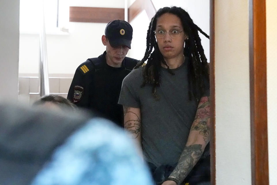 FILE - WNBA star and two-time Olympic gold medalist Brittney Griner is escorted to a courtroom for a hearing, in Khimki just outside Moscow, Russia, Monday, June 27, 2022. Her case not only brought unprecedented public attention to the dozens of Americans wrongfully detained by foreign governments, but it also emerged as a major inflection point in U.S.-Russia diplomacy at a time of deteriorating relations prompted by Moscow’s war against Ukraine. (AP Photo/Alexander Zemlianichenko, File)