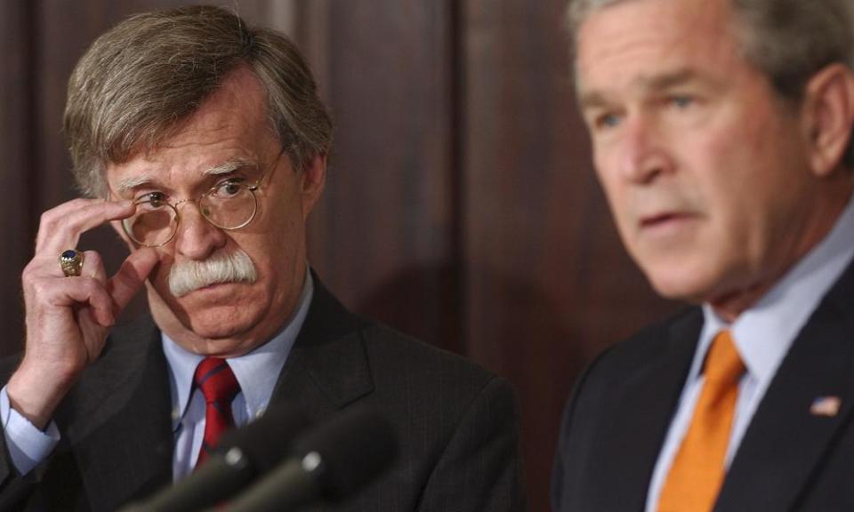 John Bolton listens to George W Bush at the White House in 2005.