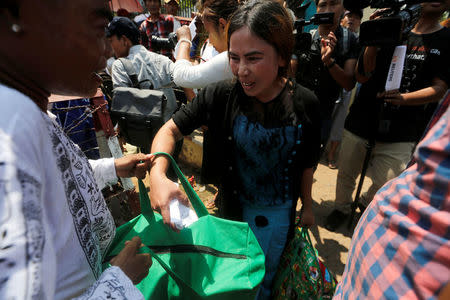 Newly released prisoners, part of over 8,000 inmates granted amnesty by Myanmar's President Win Myint to mark Myanmar's new year, walk out from Insein prison in Yangon, Myanmar April 17, 2018. REUTERS/Ann Wang