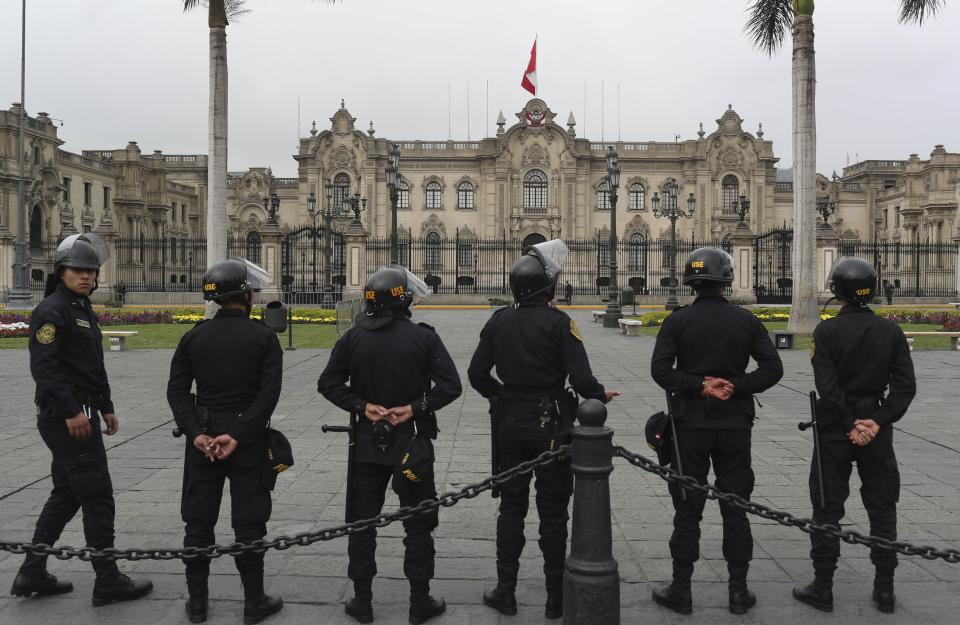 Police stand guard outside the government palace in Lima, Peru, Tuesday, Oct. 1, 2019. Peruvian President Martín Vizcarra dissolved the opposition-controlled congress and called new elections on Monday, saying the step was needed to uproot the nation's endemic corruption. (AP Photo/Martin Mejia)