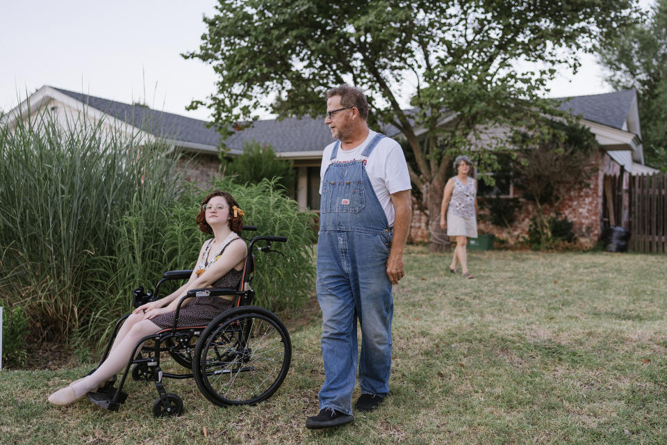 Ellis and her family in front of their house. She often uses a wheelchair due to her Ehlers-Danlos syndrome. "If there's a brace for something on your body, I probably have it," Ellis says.<span class="copyright">Morgan Lieberman</span>