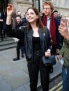 Anne Hathaway greets the crowd on Thursday while leaving her hotel in London ahead of a taping of <em>The Graham Norton Show.</em>