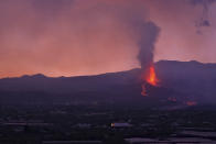 Lava flows from a volcano on the Canary island of La Palma, Spain in the early hours of Sunday Sept. 26, 2021. A volcano in Spain's Canary Islands is keeping nerves on edge several days since it erupted, producing loud explosions, a huge ash cloud and cracking open a new fissure that spewed out more fiery molten rock. (AP Photo/Daniel Roca)