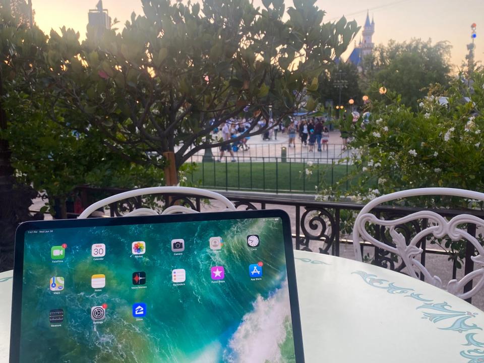 ipad out on a table in front of sleeping beauty castle