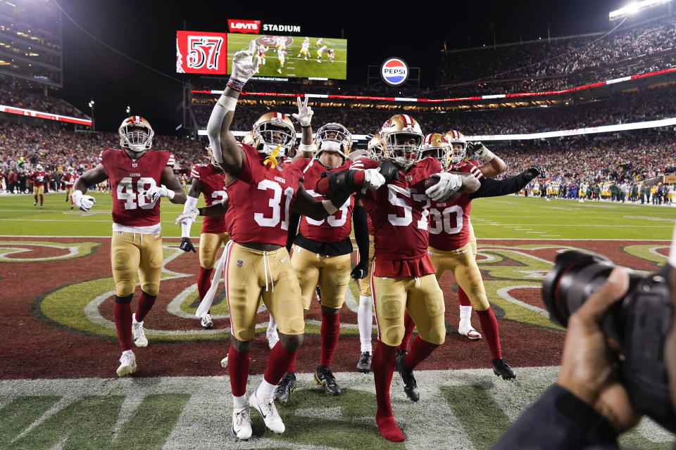 San Francisco 49ers linebacker Dre Greenlaw (57) celebrates with teammates after intercepting a pass during the second half an NFL football NFC divisional playoff game against the Green Bay Packers, Saturday, Jan. 20, 2024, in Santa Clara, Calif. (AP Photo/Godofredo A. Vásquez)