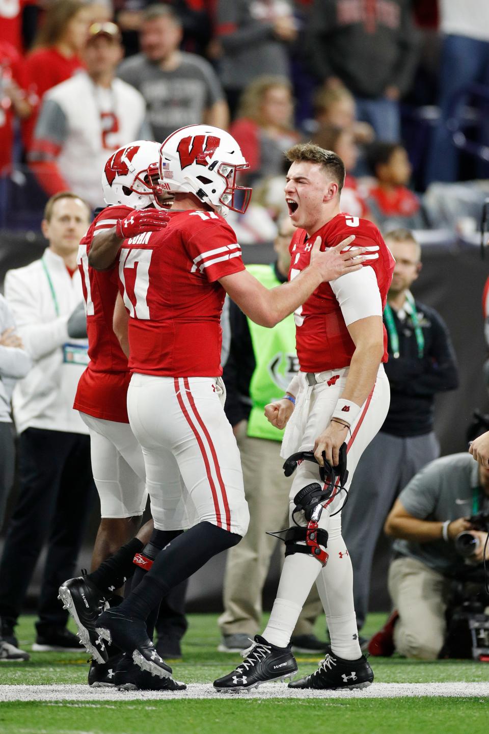 Jack Coan, left, celebrates with Graham Mertz after rushing for a 14-yard touchdown against Ohio State, helping the Badgers build a 21-7 first-half lead before faltering in the 2019 Big Ten Championship Game.