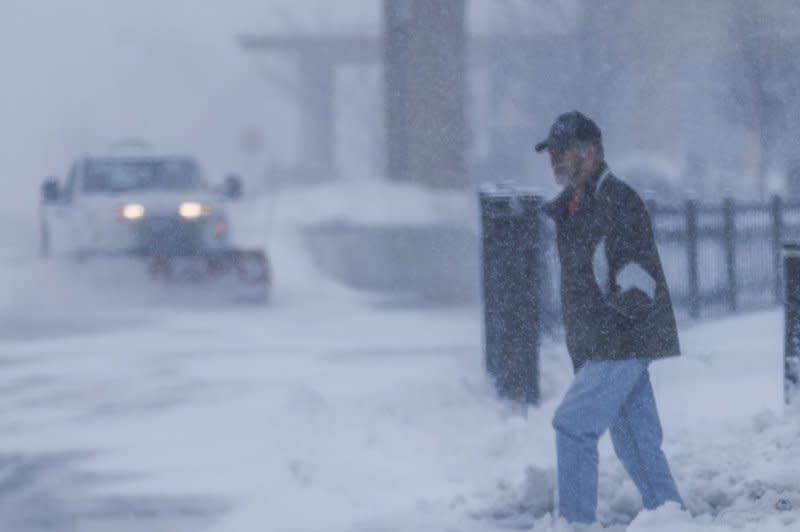 A man walks through snow in the parking lot of a casino as a winter storm hits the area dropping temperatures to extreme sub-freezing levels in Altoona, Iowa, on Friday. Republican presidential candidates campaigning for the Iowa Caucus have been forced to cancel events because of the dangerous weather conditions. Photo by Tannen Maury/UPI