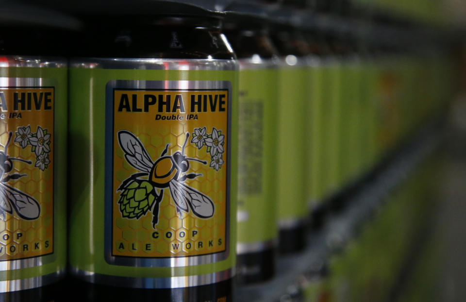 Cans of spring seasonal Alpha Hive Double IPA are ready to be filled with beer at COOP Ale Works in Oklahoma City, Friday, Jan. 18, 2019. COOP Ale Works, which distributes in six states including Oklahoma and Kansas, has discontinued two of its three 3.2 percent brews. (AP Photo/Sue Ogrocki)