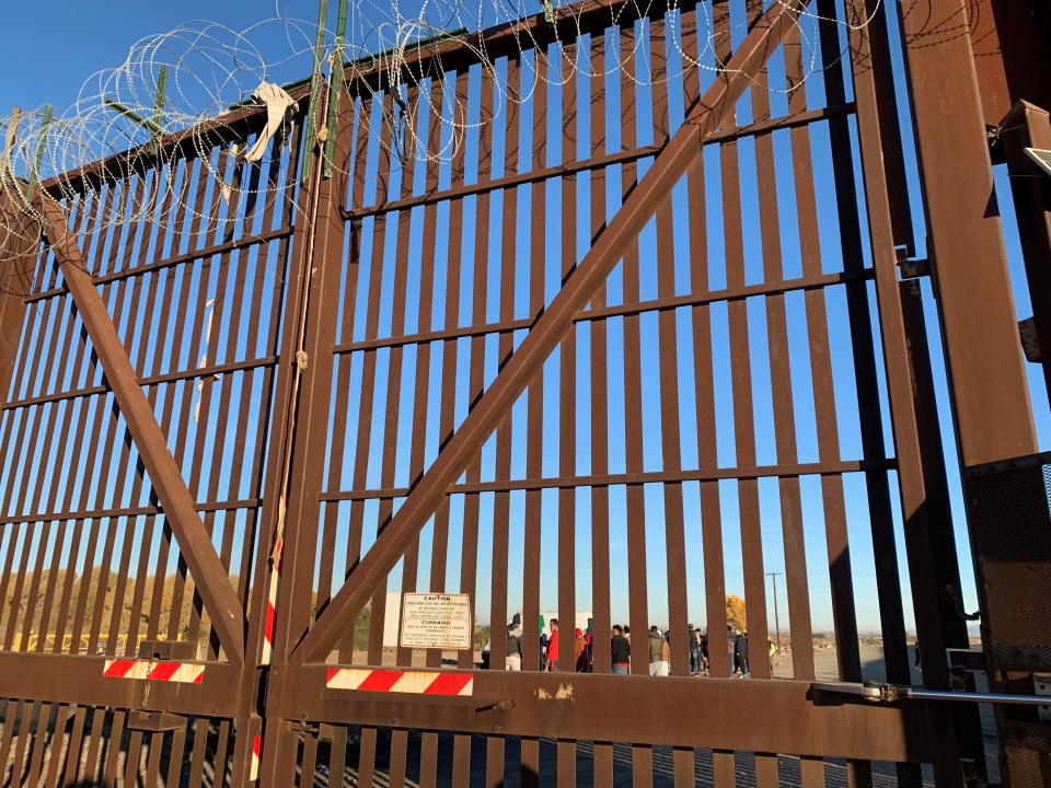 Large metal gates west of the San Luis port of entry prevent migrants who crossed the Colorado River into the U.S. from trampling leafy greens in nearby fields on Dec. 22, 2022.