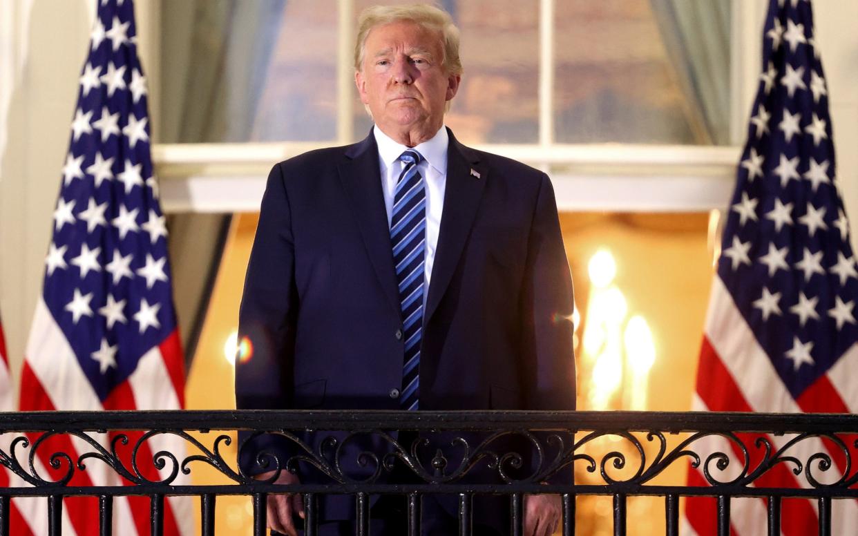 Trump stands on the Truman Balcony after returning to the White House following his coronavirus hospitalisation - Getty /Win McNamee