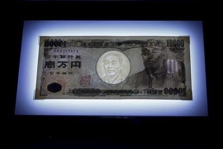A 10,000 yen bill is seen on display on top of a light panel to make its security features visible at the Currency Museum of the Bank of Japan in Tokyo, November 18, 2015. Picture taken November 18, 2015. REUTERS/Thomas Peter
