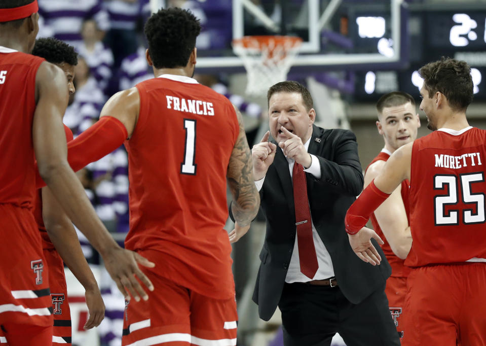 Texas Tech head coach Chris Beard, center, cheers on Tariq Owens (11), Brandone Francis (1), Davide Moretti (25) and Matt Mooney, right rear, during a time out late in the second half of an NCAA college basketball game against TCU in Fort Worth, Texas, Saturday, March 2, 2019. (AP Photo/Tony Gutierrez)