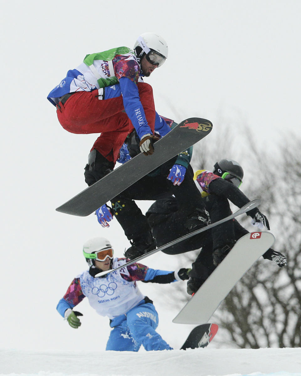 France's Pierre Vaultier, top, competes during the men's snowboard cross quarterfinal at the Rosa Khutor Extreme Park, at the 2014 Winter Olympics, Tuesday, Feb. 18, 2014, in Krasnaya Polyana, Russia. Vaultier won the gold medal. (AP Photo/Jae C. Hong)