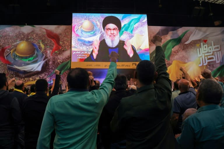 Hezbollah supporters watch their leader Hassan Nasrallah's speech on a big screen at a Quds (Jerusalem) Day gathering in Beirut's southern suburbs (ANWAR AMRO)