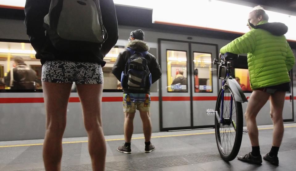 Passengers without their pants wait on a underground platform during the "No Pants Subway Ride" in Vienna