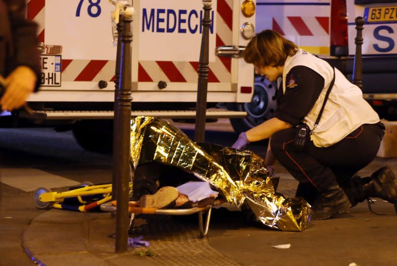 Victims of the shooting at the Bataclan concert venue in central Paris are being evacuated to receive first aid on November 14, 2015. File Photo by Maya Vidon-White/UPI