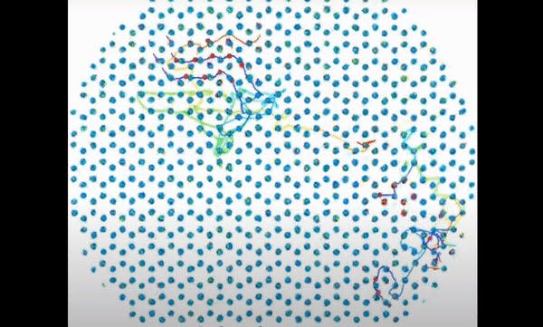 An animation shows individual atoms shifting around inside a lattice made of hexagonal shapes. 
