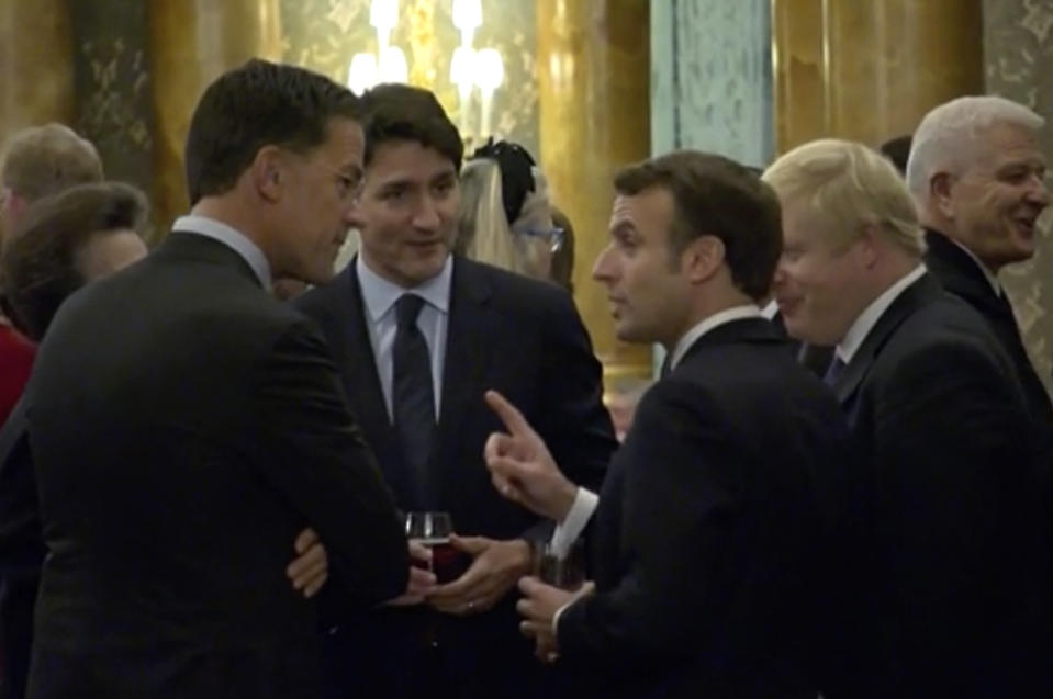 In this grab taken from video on Tuesday, Dec. 3, 2019, France's President Emmanuel Macro, centre right, gestures as he speaks during a NATO reception. While NATO leaders are professing unity as they gather for a summit near London, several seem to have been caught in an unguarded exchange on camera apparently gossiping about U.S. President Donald Trump’s behavior. In footage recorded during a reception at Buckingham Palace on Tuesday, Canadian Prime Minister Justin Trudeau was seen standing in a huddle with French President Emmanuel Macron, British Prime Minister Boris Johnson, Dutch Prime Minister Mark Rutte and Britain’s Princess Anne. (Host Broadcaster via AP)