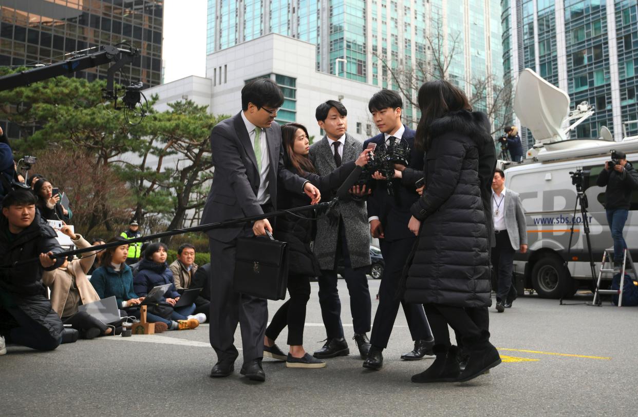 Seungri (2nd R), a member of the K-pop boy group BIGBANG, arrives for questioning over criminal allegations at the Seoul Metropolitan Police Agency in Seoul on March 14, 2019. – South Korean pop star Seungri on March 11 announced his retirement from show business amid mounting criminal investigations including his alleged involvement in a sex-for-investments scandal. (Photo by JUNG Yeon-Je / AFP) (Photo credit should read JUNG YEON-JE/AFP/Getty Images)