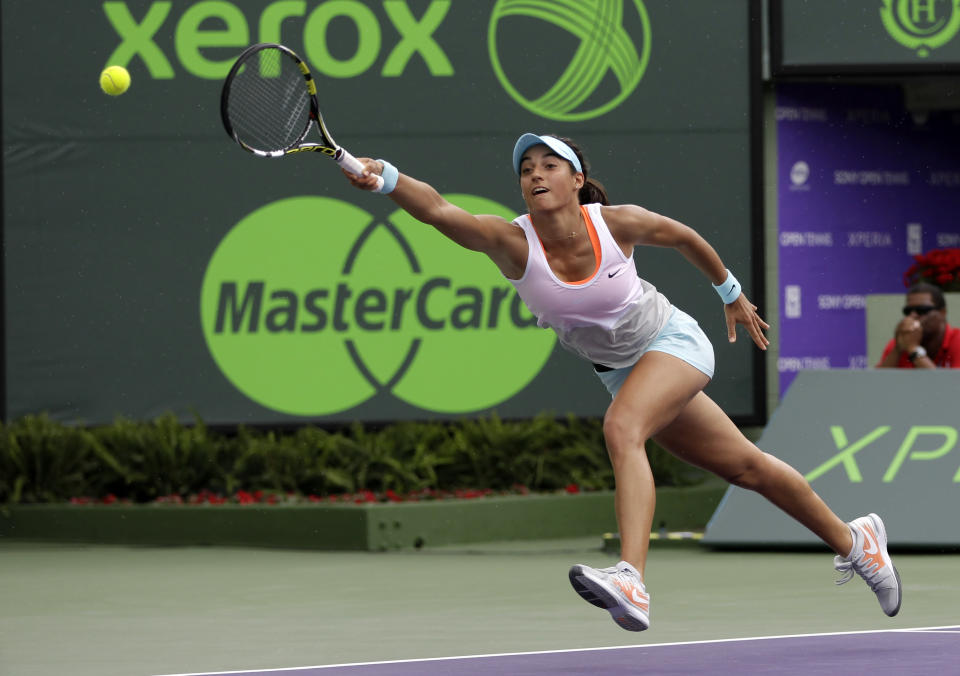 Caroline Garcia, of France, reaches as she tries to return to Serena Williams, of the United States, at the Sony Open tennis tournament in Key Biscayne, Fla., Saturday, March 22, 2014. (AP Photo/Alan Diaz)