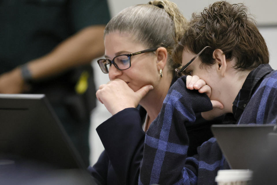 Marjory Stoneman Douglas High School shooter Nikolas Cruz looks at Assistant Public Defender Nawal Bashimam's computer screen during the penalty phase of his trial at the Broward County Courthouse in Fort Lauderdale on Monday, Oct. 3, 2022. Cruz previously plead guilty to all 17 counts of premeditated murder and 17 counts of attempted murder in the 2018 shootings. (Amy Beth Bennett/South Florida Sun Sentinel via AP, Pool)