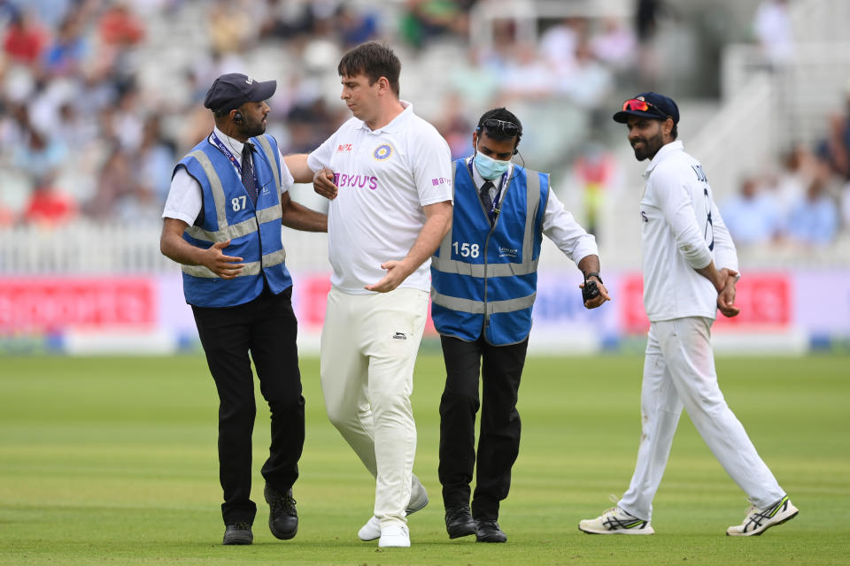 LONDON, ENGLAND - AUGUST 14: A pitch intruder is removed during the Second LV= Insurance Test Match: Day Three between England and India at Lord's Cricket Ground on August 14, 2021 in London, England. (Photo by Mike Hewitt/Getty Images)