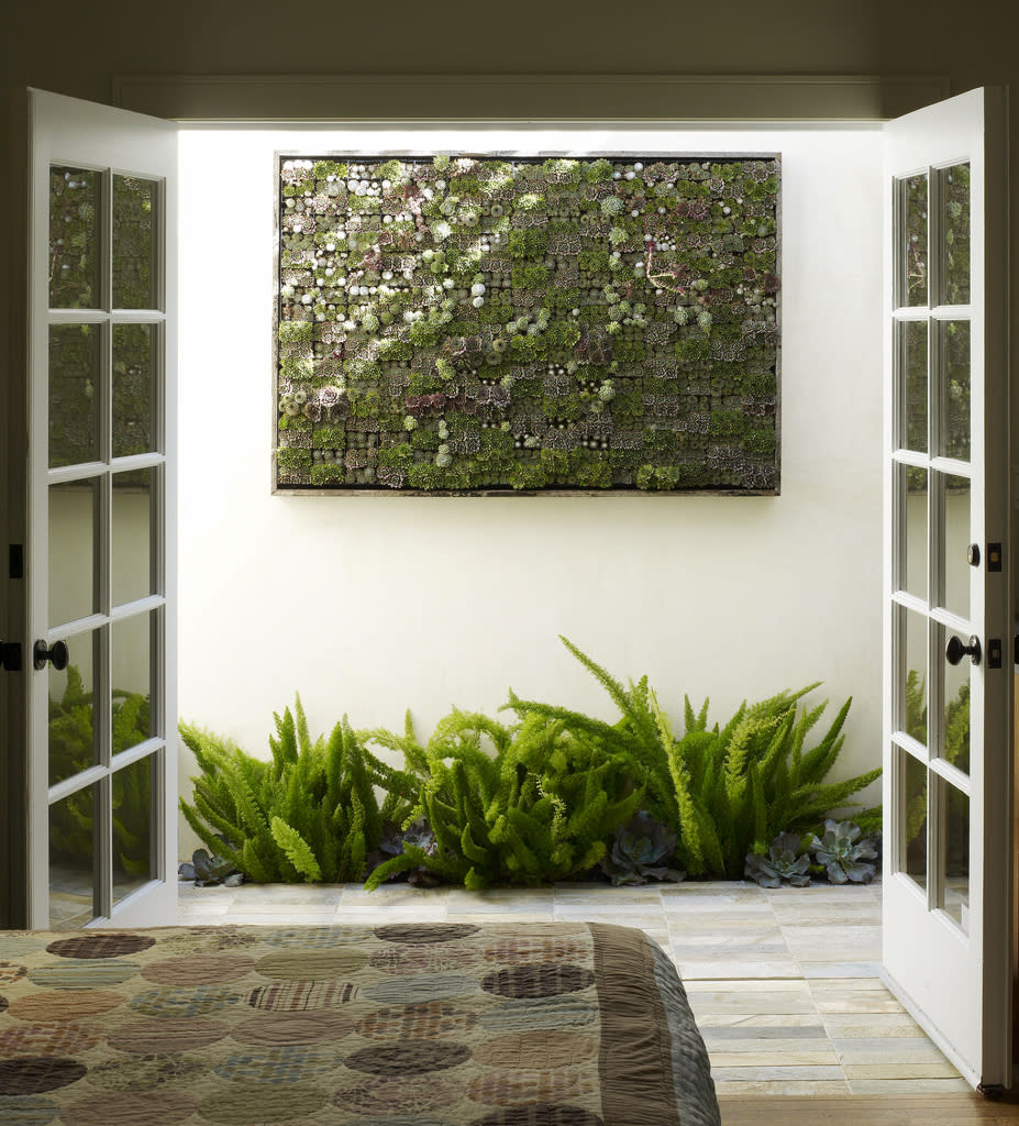 This undated publicity photo courtesy of Flora Grubb Gardens shows a large living succulent picture hanging outside a bedroom in San Francisco. Living pictures, cuttings of assorted succulents woven together in everything from picture frames to pallet boxes, are hot among garden designers and landscapers this spring as an easy, modern way to add color and texture to an outdoor space. (AP Photo/Flora Grubb Gardens, Marion Brenner)